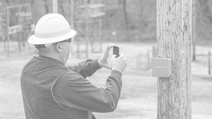 Utility Worker Calibrating an Atom in the Field